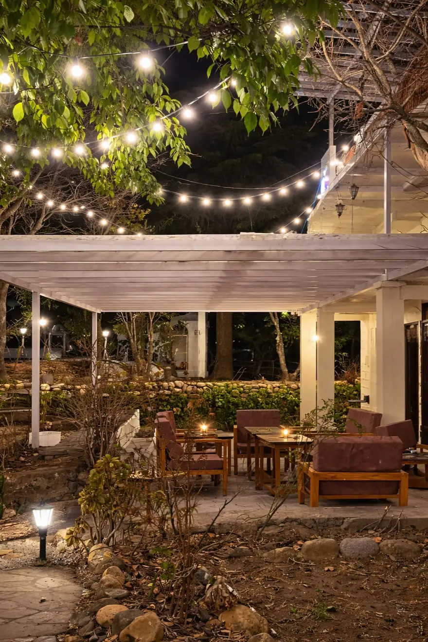 Outdoor café seating with string lights at Haus of Shizu café in Kasar Devi at night
