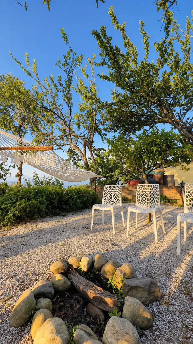 Hammock, garden chairs and stone fire pit in the private garden at Haus of Shizu, Kasar Devi