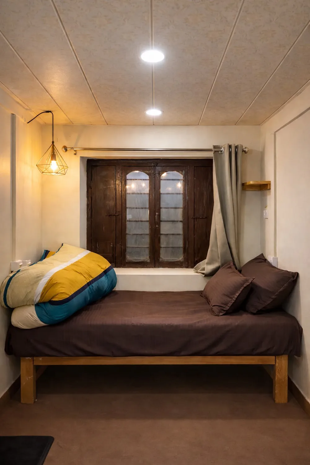 Daybed room with old wooden shutters at Haus of Shizu Airbnb in Kasar Devi, Uttarakhand